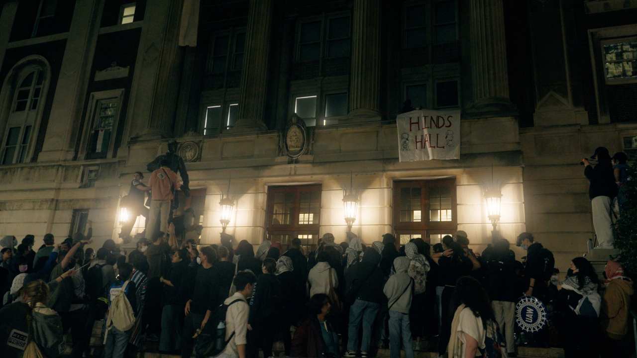 a large crowd of protestors in front of a building
